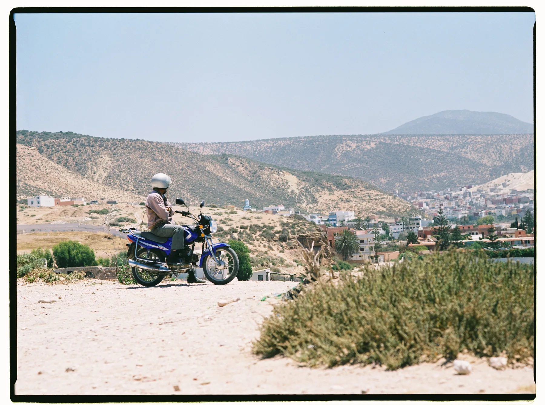 Motorcyclist overlooking a Moroccan landscape